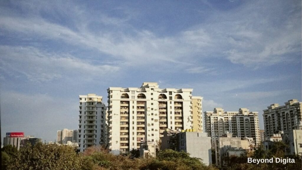 Real estate digital marketing in Delhi NCR, apartment towers under a blue sky, Beyond Digita